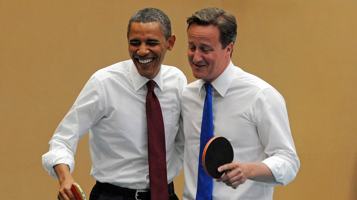 U.S. President Barack Obama, left, and Britain's Prime Minister David Cameron laugh as they play table tennis at Globe Academy, in south London Tuesday May 24, 2011. AP