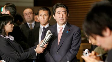 Japan's Prime Minister Shinzo Abe, center, speaks to reporters at the prime minister's official residence in Tokyo, Wednesday, Jan. 21, 2015, shortly after returning from his six-day Middle East tour. AP