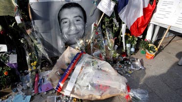 The wreath of flowers laid at the spot where police officer Ahmed Merabet, featured in photo, was killed in Paris. (AP)