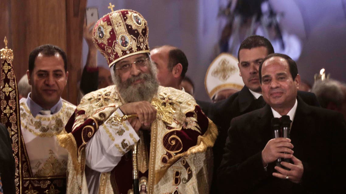 Egypt's President Abdel-Fattah el-Sissi, right, visits Coptic Pope Tawadros II, center, during Christmas Eve Mass at St. Mark's Cathedral, in Cairo, Egypt, Tuesday, Jan. 6, 2015. AP