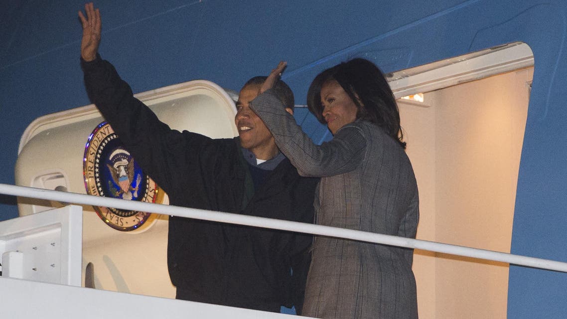 U.S. President Barack Obama and First Lady Michelle Obama board Air Force One prior to departing from Andrews Air Force Base in Maryland, on Jan. 24, 2015. (AFP)