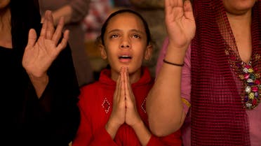 In this Thursday, Nov. 8, 2012 picture, a Coptic girl prays during a mass at the Cave Cathedral or St. Sama'ans Church in the Moqattam area, Cairo, Egypt. Egypt's Christian minority, about 10 percent of the population of more than 80 million, has long complained of discrimination. AP