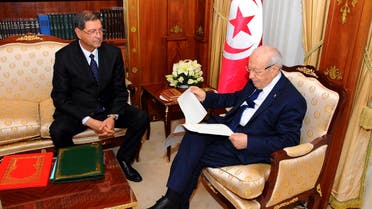 Tunisia's nominated prime minister Habib Essid (L) gives the list of the new government to President Beji Caid Essebsi in Tunis January 23, 2015. (Reuters)