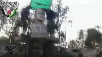 Opposition forces demolish Hafez al-Assad bust in Syria’s Deraa