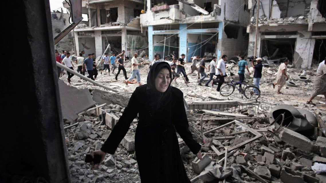 In this July 26, 2014 file photo, a Palestinian woman reacts after seeing her destroyed house during a 12-hour cease-fire in Gaza City's Shijaiyah neighborhood. AP