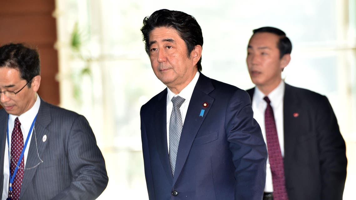Japanese Prime Minister Shinzo Abe (C) walks at his official residence in Tokyo after a cabinet meeting on January 27, 2015. AFP