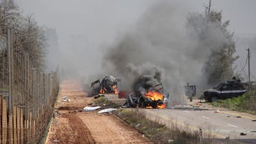 Burning vehicles are seen near the village of Ghajar on Israel's border with Lebanon Jan. 28, 2015. (Reuters)
