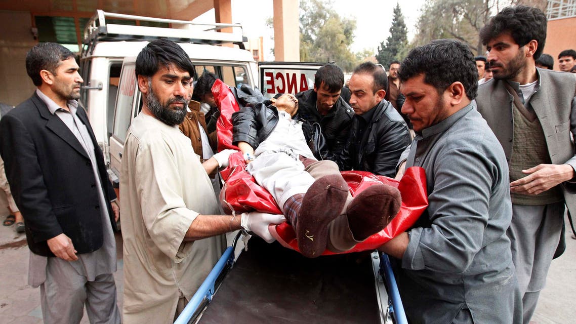 Afghan men carry a wounded man at a hospital in Jalalabad, after a suicide attack which targeted funeral prayers in Laghman province, January 29, 2015. (Reuters)