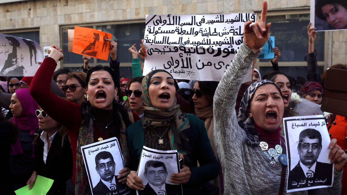 Protesters chant anti-government slogans while holding posters of Egyptian Interior Minister Mohamed Ibrahim with the words, "Wanted, the killer of Shaimaa al-Sabbagh" (Reuters)