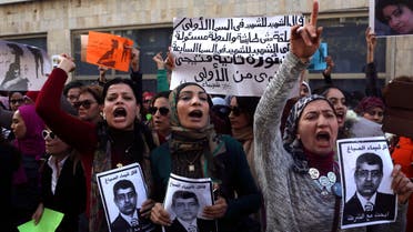 Protesters chant anti-government slogans while holding posters of Egyptian Interior Minister Mohamed Ibrahim with the words, "Wanted, the killer of Shaimaa al-Sabbagh" (Reuters)