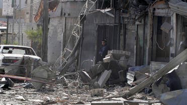 A man stands at a site hit by what activists said was an airstrike by forces loyal to Syria's President Bashar al-Assad in the Duma neighbourhood of Damascus January 28, 2015. (Reuters)