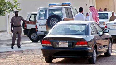 Saudi police officers check the site of the Khaleej neighborhood of eastern Riyadh, Saudi Arabia, Tuesday, June 8, 2004, where an American citizen was shot and killed. The victim worked for Vinnell Corp.,