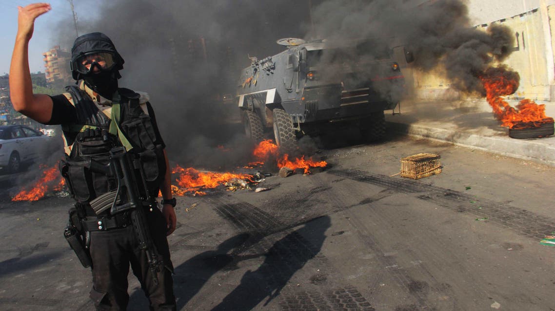 An Egyptian security forces member directs others near Suez Bridge district, Egypt, Thursday, July 3, 2014. (AP)