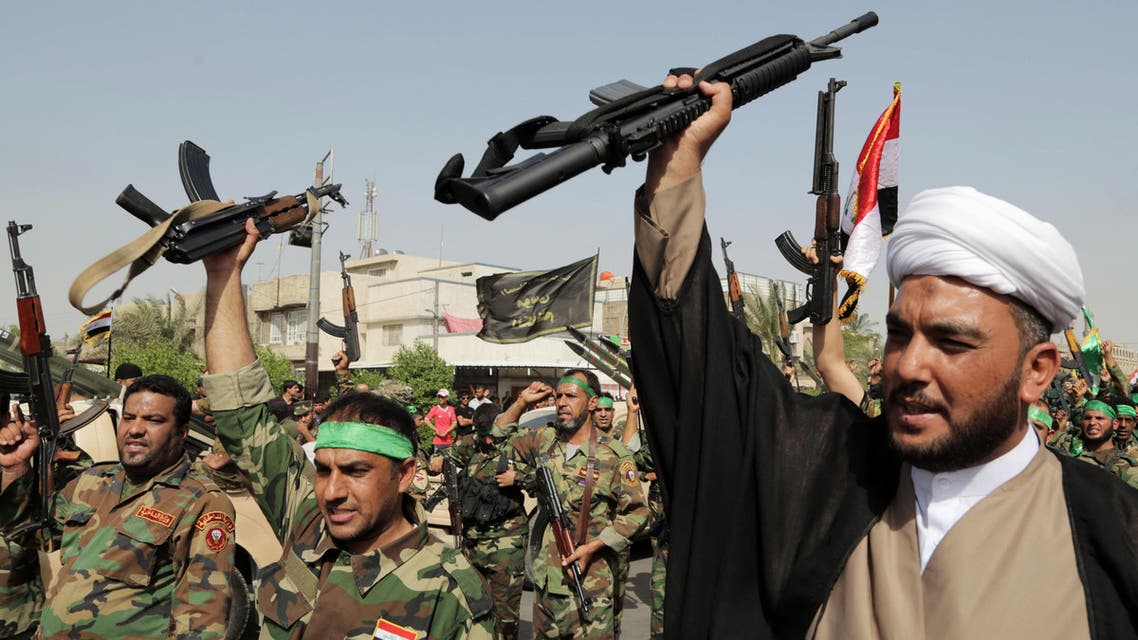 volunteers of the newly formed "Peace Brigades" raise their weapons and chant slogans against the al-Qaida-inspired Islamic State of Iraq and the Levant during a parade in the Shiite stronghold of Sadr City, Baghdad, Iraq. (AP)