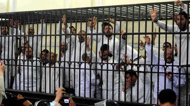 Supporters of the Muslim Brotherhood and ousted President Mohamed Morsi, standing trial on charges of violence that broke out in August 2013, react after two fellow supporters were sentenced to death, in a court in Alexandria, March 29, 2014. Photo: REUTERS