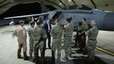 British Prime Minister David Cameron meets pilots, engineers and logistic support staff in front of a Tornado GR4 at RAF Akrotiri base, Cyprus, Thursday, Oct. 2, 2014. (Reuters)