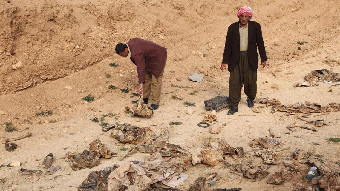 Members of the Yazidi sect look for the remains of their relatives in a mass grave on the outskirts of the town of Sinjar, February 3, 2015. (Reuters)