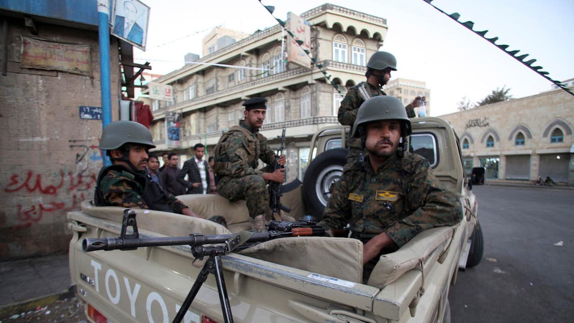 Houthi fighters in police uniform guard outside the presidential palace in Sanaa February 6, 2015. (Reuters)