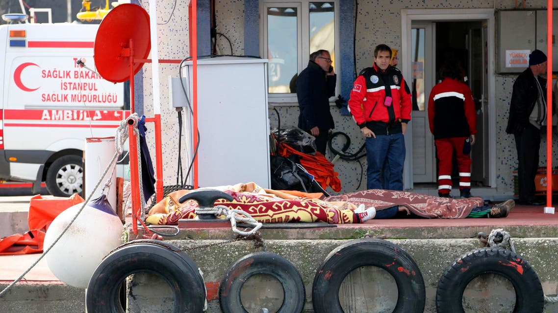 Dead bodies covered with blankets lie on the ground after a boat carrying suspected migrants from Afghanistan and Syria sank just north of the Bosphorus Strait off the coast of Istanbul, Turkey, Monday, Nov. 3, 2014, leaving at least 24 people dead and several people missing. Seven people were rescued, Turkish authorities said.(AP Photo)