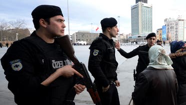 Police officers ask people to stay away at the main Taksim Square in Istanbul, Turkey, Friday, Jan. 30, 2015, after a woman opened automatic weapon fire at a police vehicle in Taksim, before escaping on foot.  (AP)