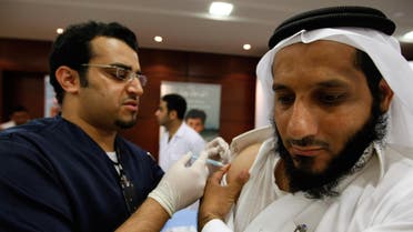 A Saudi Arabian Health Ministry employee, right, is administered a swine flu vaccine during the launch of a swine flu vaccine campaign in Riyadh, Saudi Arabia. (File photo: AP)
