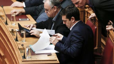 Greek Minister Alexis Tsipras front and his Finance Minister Yanis Varoufakis, right, look on papers during the vote for the president of Greece's parliament in Athens, on Friday, Feb. 6, 2015. (AP)