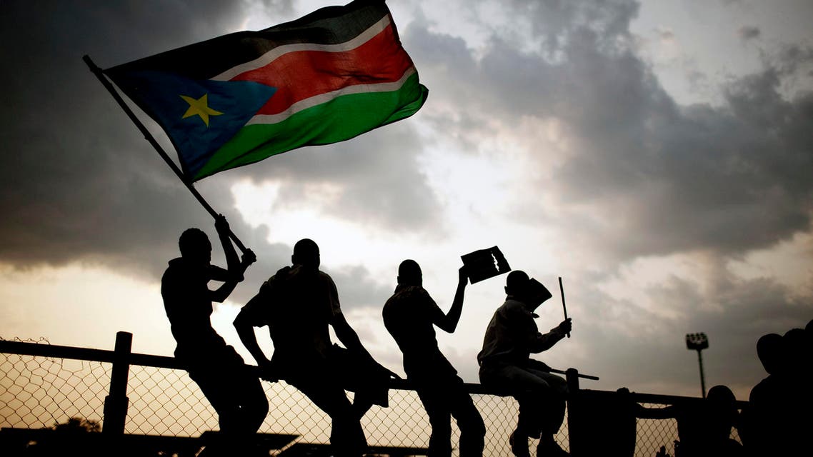 Southern Sudanese wave flags and cheer at the Republic of South Sudan's first national soccer match in the capital of Juba on Sunday, July 10, 2011.  (AP)