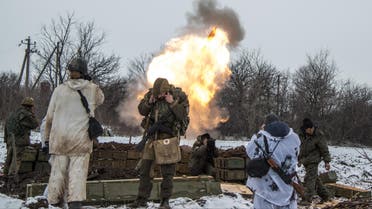 Russian-backed separatists cover their ears as they fire a mortar towards Ukrainian troops outside the village of Sanzharivka, northeast of Debaltseve, eastern Ukraine, Wednesday, Feb. 11, 2015.(AP)