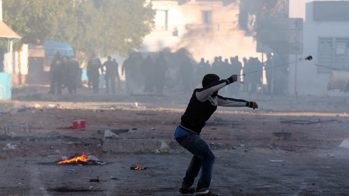A Tunisian resident of the southeastern town of Ben Guerdane uses a sling shot to throw stones towards riot police on Feb. 10, 2015. (AFP)