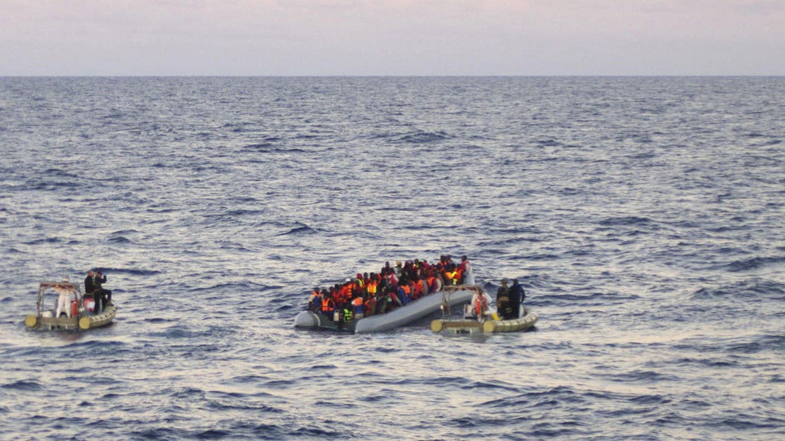 In this file photo taken on Thursday, Dec. 4, 2014 provided by the Italian Navy, rescue crews approach migrants on a rubber boat some 40 miles (65 kilometers) from the Libyan capital, Tripoli. Rescue crews discovered 16 bodies in a migrant boat off Libya, the first reported deaths since the European Union took over Mediterranean rescue operations, the Italian navy said Friday. AP