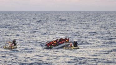 In this file photo taken on Thursday, Dec. 4, 2014 provided by the Italian Navy, rescue crews approach migrants on a rubber boat some 40 miles (65 kilometers) from the Libyan capital, Tripoli. Rescue crews discovered 16 bodies in a migrant boat off Libya, the first reported deaths since the European Union took over Mediterranean rescue operations, the Italian navy said Friday. AP