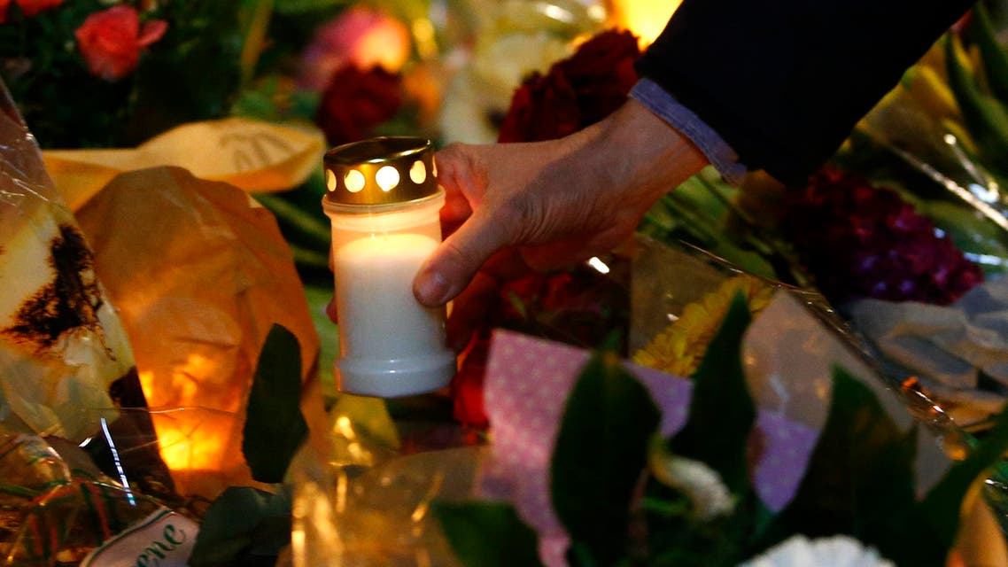 A man holds a candle at a memorial for the victims of the deadly attacks in front of the synagogue in Krystalgade in Copenhagen, February 15, 2015. (Reuters)