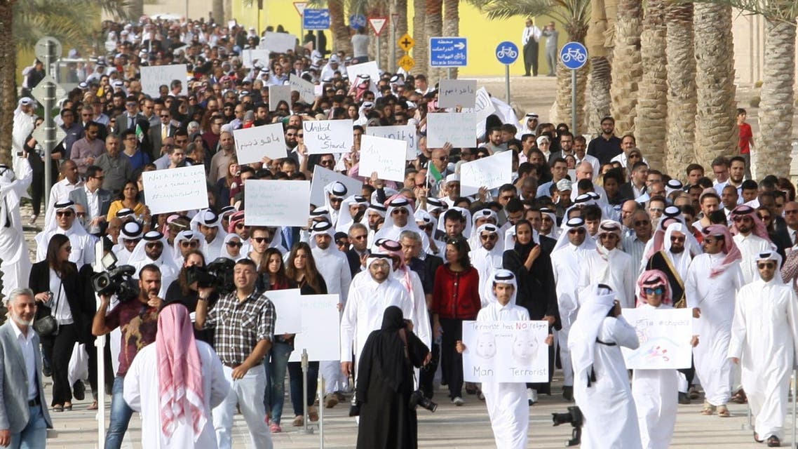 Qataris march down a street in Doha on February 15, 2015, in remembrance of the three victims of the Chapel Hill shooting in the U.S. (AFP)