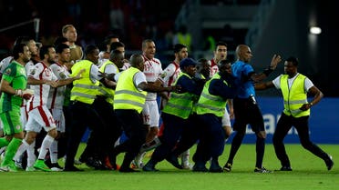 Referee Rajindraparsad Seechurn, second from right, is shielded by security personal against the Tunisia's player at the end of the African Cup of Nations quarter final soccer match against Equatorial Guinea in Bata, Equatorial Guinea, Saturday, Jan. 31, 2015. (AP) 