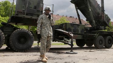 A U.S. soldier stands next to a Patriot surface-to-air missile battery at an army base in Morag, Poland. Turkey's government requested the deployment of NATO's Patriot surface-to-air missiles in 2012.(File Photo:AP)