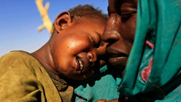 A woman carrying a child arrives at the Zamzam IDP camp for Internally Displaced Persons (IDP), near El Fasher in North Darfur February 4, 2015. (Reuters)
