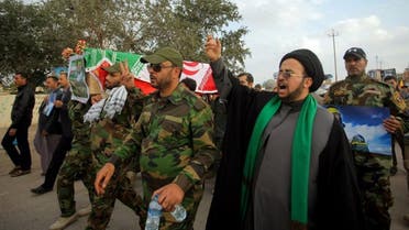  Iranian cleric Mohammed Jafari, second right, and Shiite militiamen chant slogans against ISIS as they carry a coffin draped with the Iranian flag during a funeral procession for Mohammad Hadi Zulfiqar, in the poster, an Iranian volunteer fighting in the Badr Brigades Shiite militia, in Najaf, 100 miles (160 kilometers) south of Baghdad, Iraq, Thursday, Feb. 19, 2015. (AP)