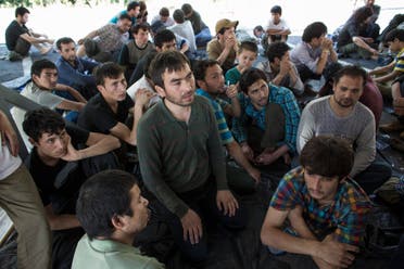 Suspected Uighurs from China's troubled far-western region of Xinjiang, sit inside a temporary shelter after they were detained at the immigration regional headquarters near the Thailand-Malaysia border in Hat Yai, Songkla March 14, 2014. (File photo: Reuters)