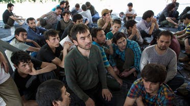 Suspected Uighurs from China's troubled far-western region of Xinjiang, sit inside a temporary shelter after they were detained at the immigration regional headquarters near the Thailand-Malaysia border in Hat Yai, Songkla March 14, 2014. (File photo: Reuters)