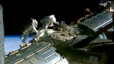 his February 21, 2015 NASA TV image shows NASA astronauts Barry Wilmore(L) and Terry Virts during a spacewalk to lay cable on the International Space Station. (AFP)