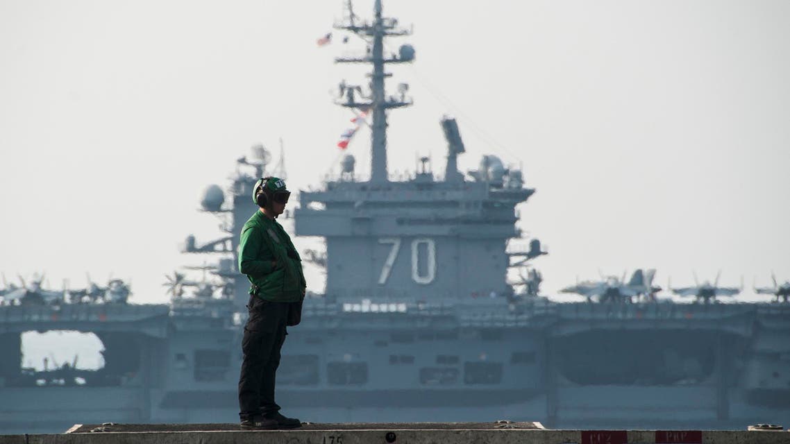 In this Oct. 18, 2014 photo provided by the U.S. Navy, the aircraft carrier USS Carl Vinson, background, sails beside the aircraft carrier USS George H.W. Bush in the Persian Gulf. (AP)