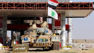 A tank belonging to the Shi'ite Badr Brigade militia takes position in front of a gas station in Suleiman Beg, northern Iraq. (File photo: Reuters)