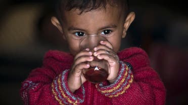 A Syrian Kurdish refugee child from the Kobane area, drinks tea at a camp in Suruc, on the Turkey-Syria border Wednesday, Nov. 12, 2014. (AP)