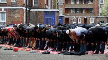 Muslims perform Friday prayers outside a housing compound in east London [Reuters]