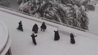 Snow day! Jerusalem monks have snowball fight on rooftop