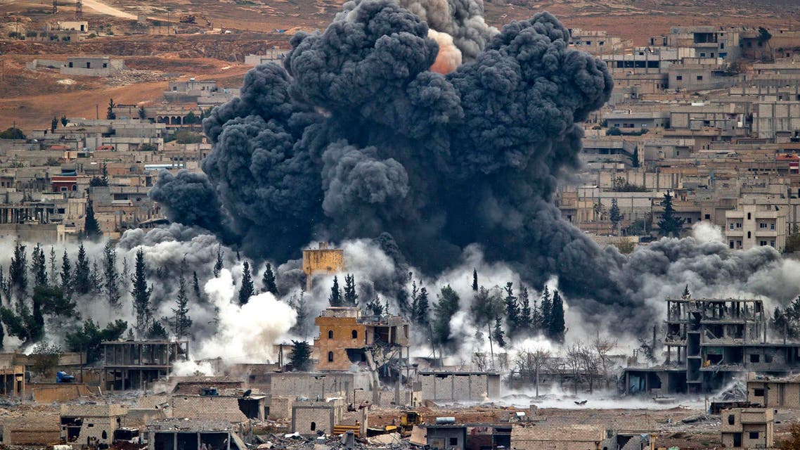 In this Nov. 17, 2014 file photo, smoke rises from the Syrian city of Kobani, following an airstrike by the U.S.-led coalition, seen from a hilltop outside Suruc, on the Turkey-Syria border. AP