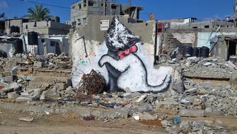 Graffitist Banksy unveils giant kitten art in Gaza video tour
