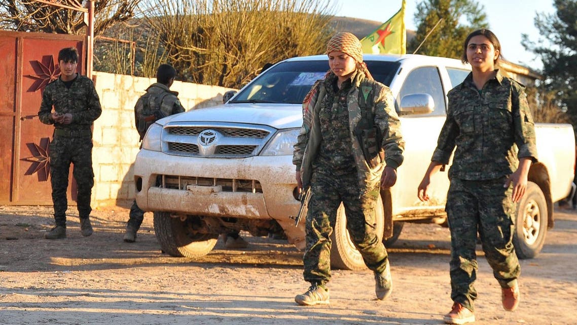 People's Protection Units (YPG) fighters walk in the town of Tal Hamis, southeast of the city of Qameshli, on Feb. 26, 2015 (AFP)
