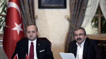 Sirri Sureyya Onder, right, speaking next to Turkey’s Deputy Prime Minister Yalcin Akdogan, left. AFP
