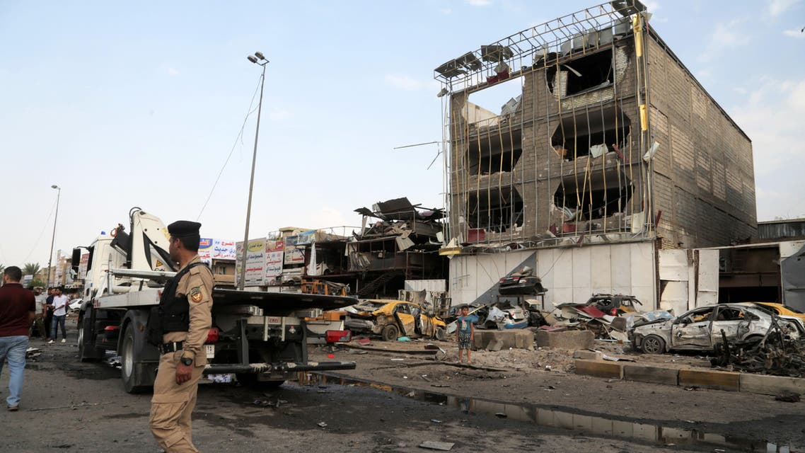 Security forces inspect the site of a car bomb explosion in the largely Shiite eastern neighborhood of Talibiyah in Baghdad, Iraq, Thursday, Oct. 16, 2014. AP